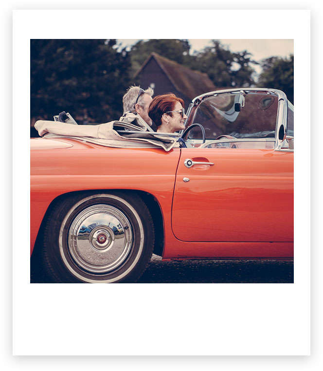 Couple in red convertible